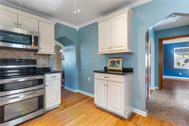 17 Long St, Hanover Twp Wsh, PA 15021 - kitchen featuring appliances with stainless steel finishes, arched walkways, baseboards, and ornamental molding