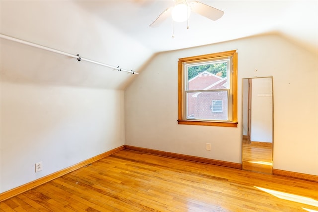 additional living space featuring ceiling fan, lofted ceiling, and light hardwood / wood-style flooring