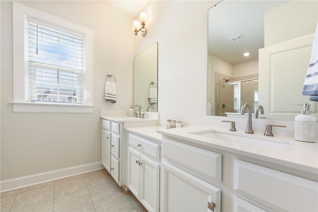 409 Spruce Ln, North Strabane, PA 15317 - bathroom with double vanity, a shower stall, tile patterned flooring, and baseboards