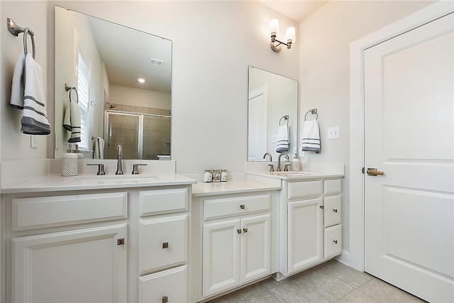 bathroom featuring vanity, walk in shower, and tile patterned floors