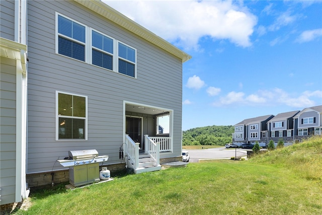 rear view of house with a yard