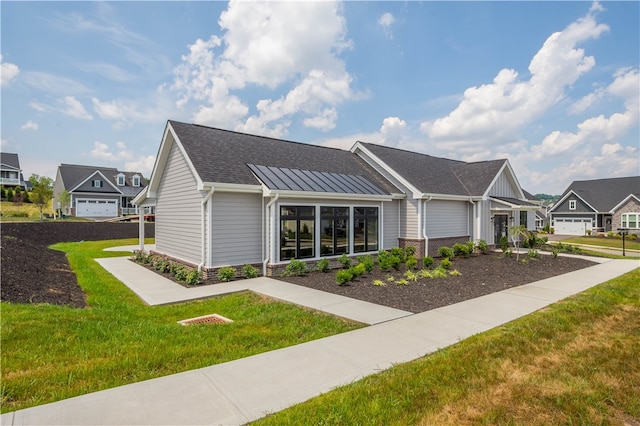 view of front of house featuring a garage and a front lawn