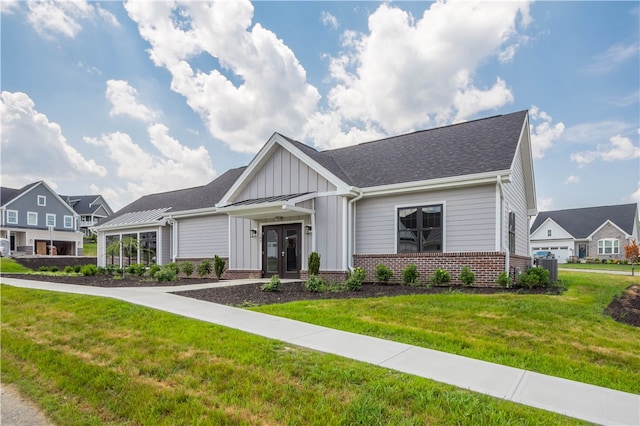 craftsman-style house with central AC and a front yard