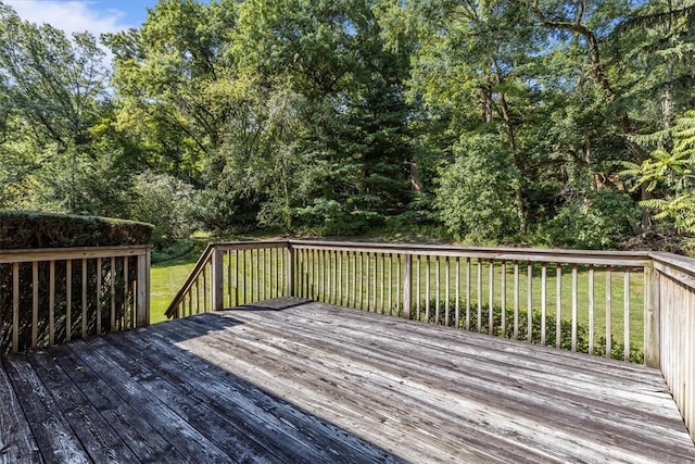 wooden terrace featuring a yard