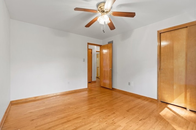 unfurnished bedroom with a closet, light wood-type flooring, and ceiling fan