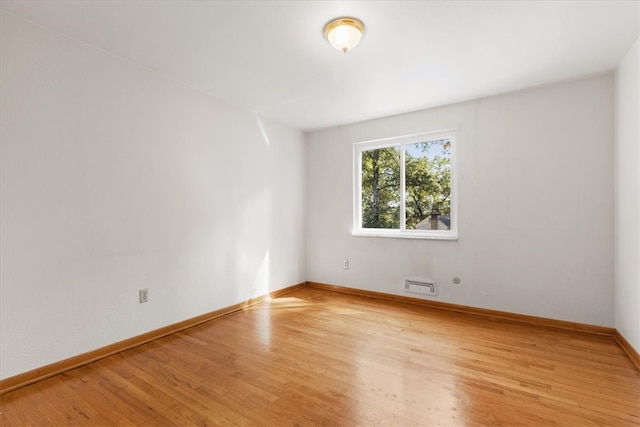 spare room featuring light hardwood / wood-style floors