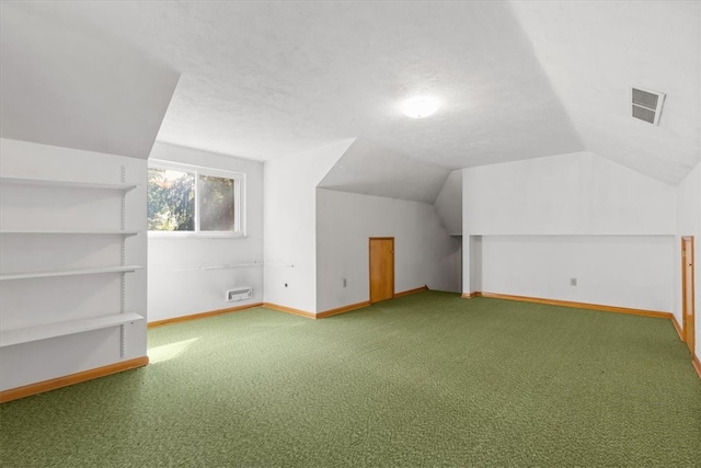 bonus room with carpet, a textured ceiling, and vaulted ceiling