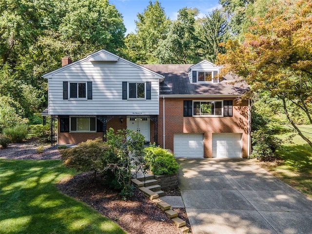 view of front of home with a garage and a front lawn