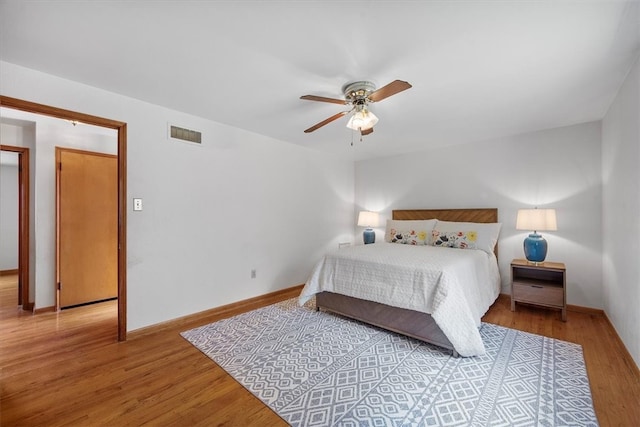 bedroom with light wood-type flooring and ceiling fan