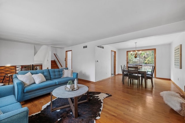 living room with hardwood / wood-style flooring and a chandelier