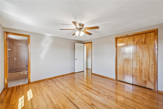 unfurnished bedroom with ceiling fan, ensuite bath, and light hardwood / wood-style floors