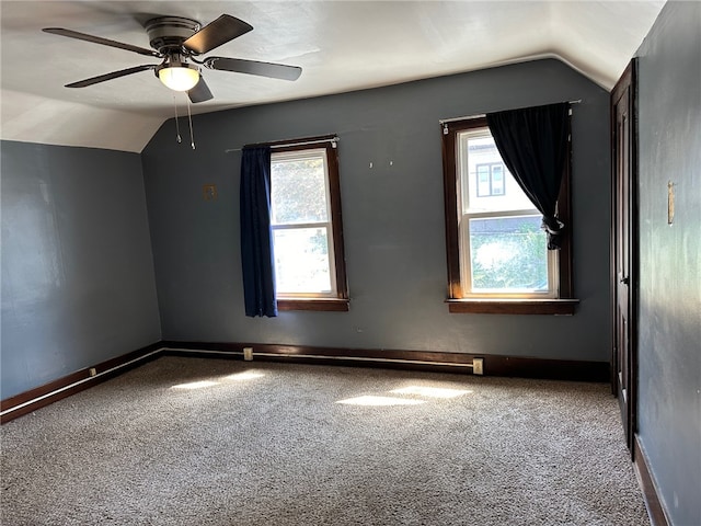 carpeted empty room with ceiling fan and vaulted ceiling