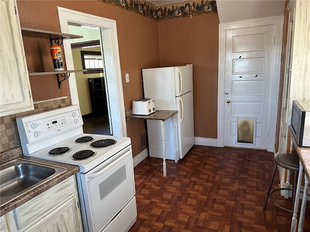 kitchen featuring dark parquet floors, white appliances, and backsplash