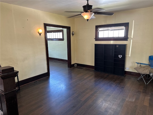 entryway with dark wood-type flooring and ceiling fan