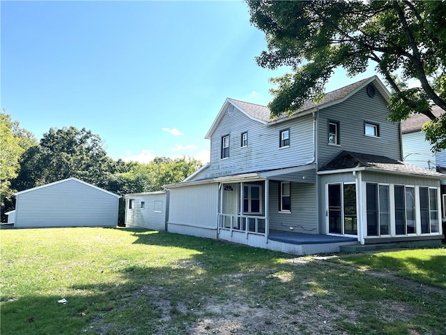 back of property featuring a lawn and a sunroom