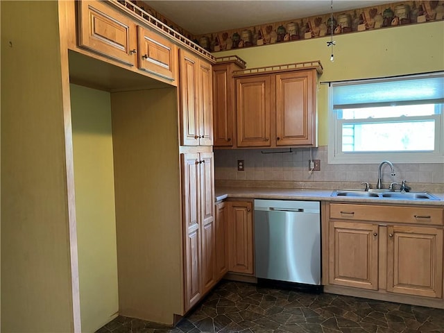 kitchen with stone finish floor, a sink, tasteful backsplash, stainless steel dishwasher, and light countertops