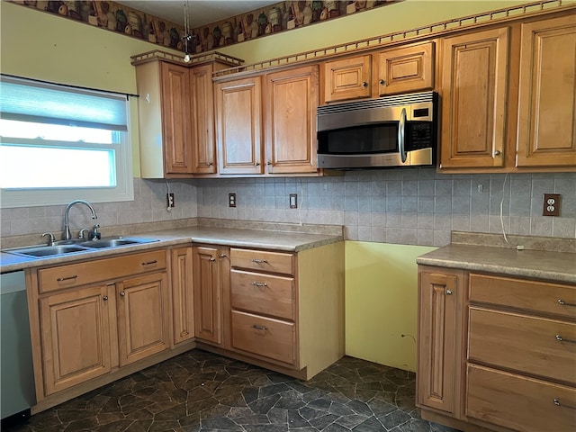 kitchen featuring sink, appliances with stainless steel finishes, and tasteful backsplash