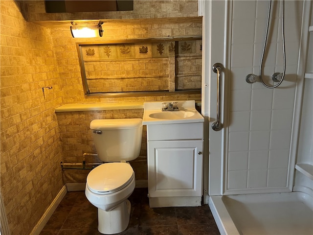 bathroom with brick wall, vanity, toilet, and walk in shower