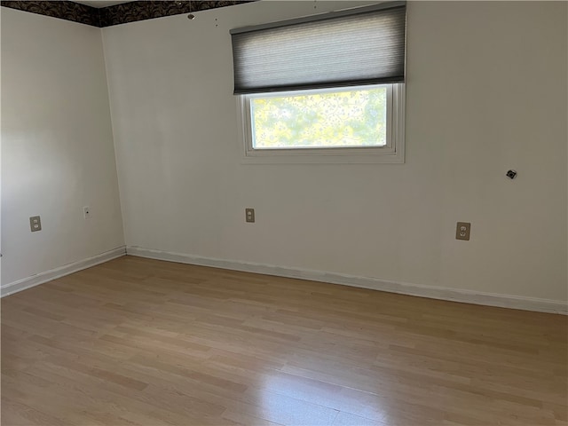 empty room with light hardwood / wood-style flooring