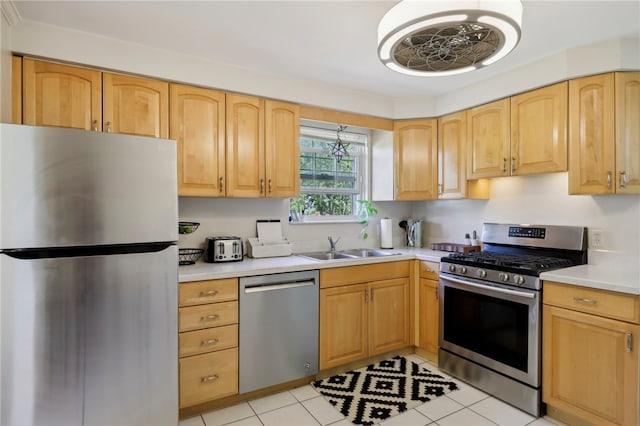 kitchen with light brown cabinets, stainless steel appliances, light tile patterned flooring, and sink