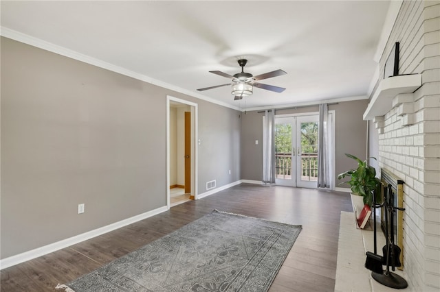 living room featuring hardwood / wood-style flooring, a fireplace, crown molding, french doors, and ceiling fan