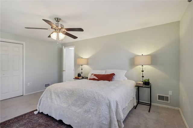 carpeted bedroom featuring ceiling fan and a closet