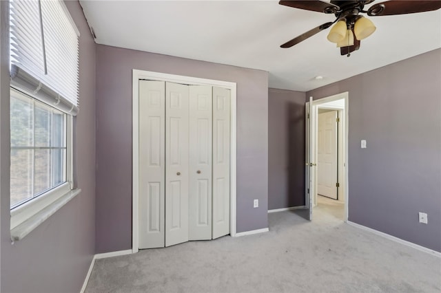 unfurnished bedroom with light carpet, ceiling fan, and a closet