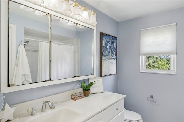 bathroom with vanity, toilet, and a shower with curtain