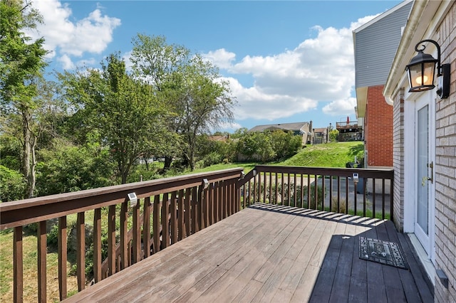 wooden deck with a lawn