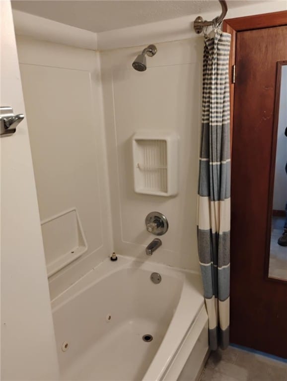 bathroom with shower / bath combo with shower curtain