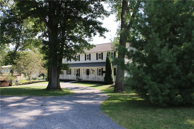 colonial inspired home featuring a front lawn and a porch