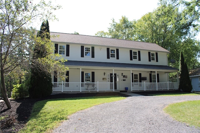 view of front of house with a porch and a front lawn