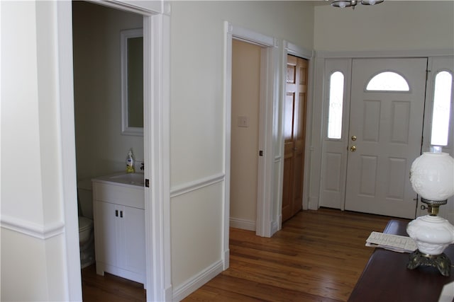 entryway with dark wood-type flooring