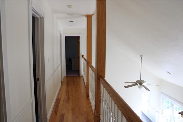 hall featuring lofted ceiling and light hardwood / wood-style floors