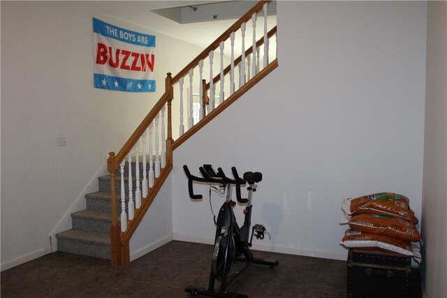 workout room with dark colored carpet