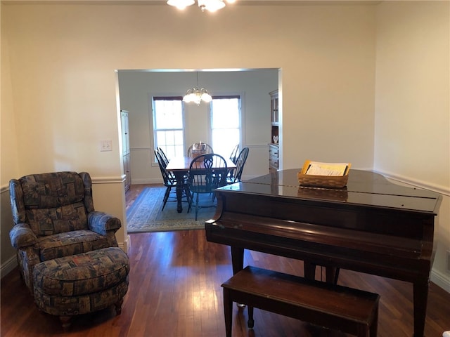 misc room with an inviting chandelier and dark wood-type flooring