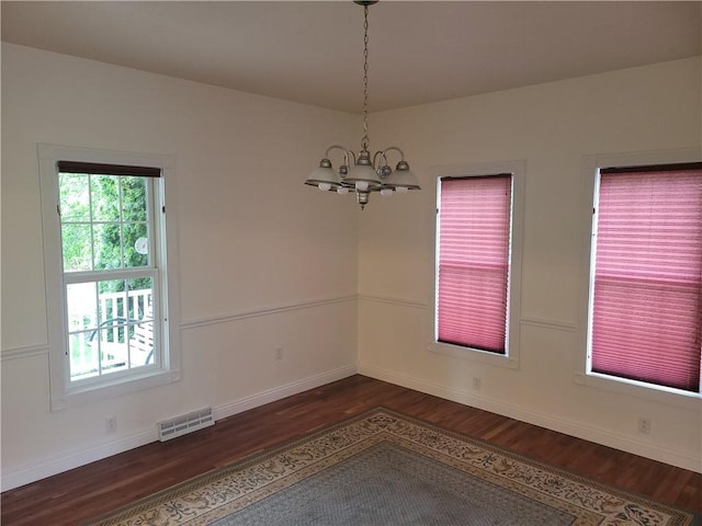 629 Euclid Ave, Grove City Boro, PA 16127 - unfurnished room featuring dark wood-style floors, a chandelier, and baseboards