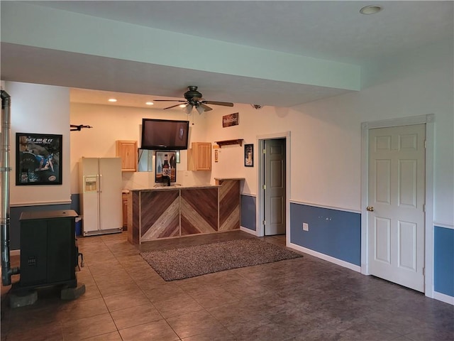 629 Euclid Ave, Grove City Boro, PA 16127 - kitchen with white fridge with ice dispenser, a peninsula, a ceiling fan, a wood stove, and baseboards