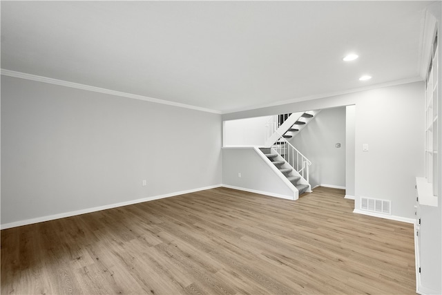 spare room featuring crown molding and hardwood / wood-style floors