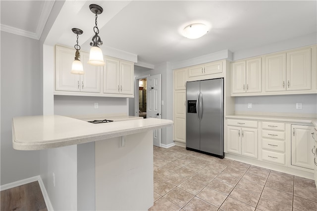 kitchen with pendant lighting, ornamental molding, a kitchen bar, light tile patterned floors, and stainless steel fridge with ice dispenser