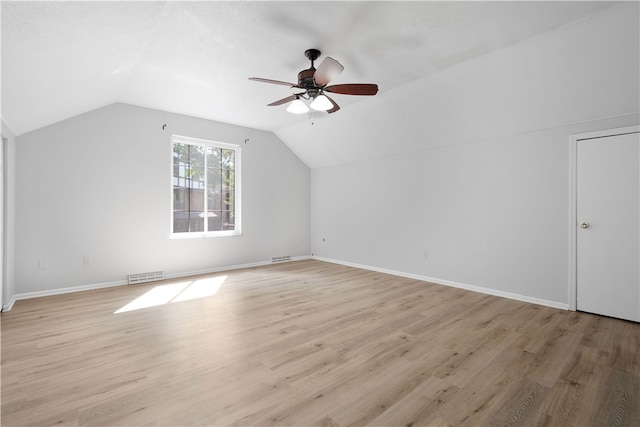 additional living space with ceiling fan, light wood-type flooring, and vaulted ceiling