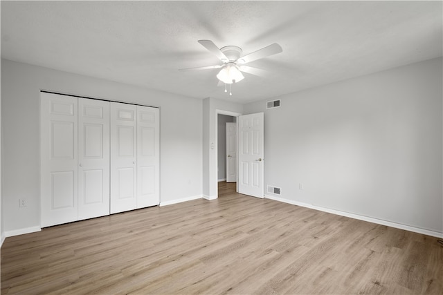 unfurnished bedroom featuring a closet, ceiling fan, and light hardwood / wood-style flooring