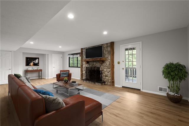 living room with a fireplace and light hardwood / wood-style floors