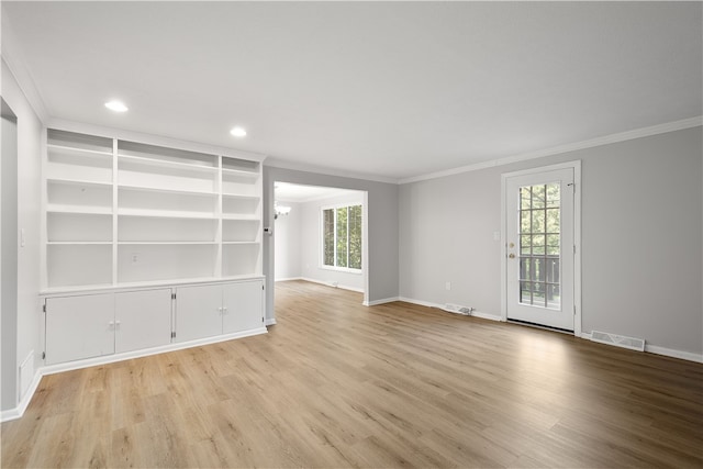 empty room with hardwood / wood-style flooring, plenty of natural light, and ornamental molding