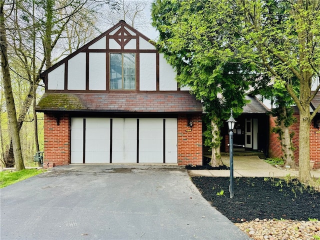 english style home with a garage