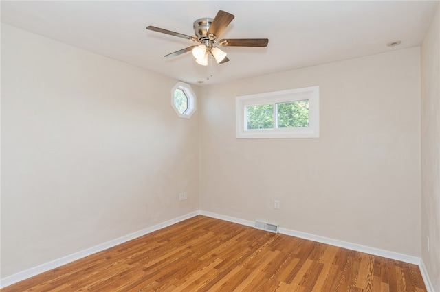 spare room with ceiling fan and hardwood / wood-style flooring