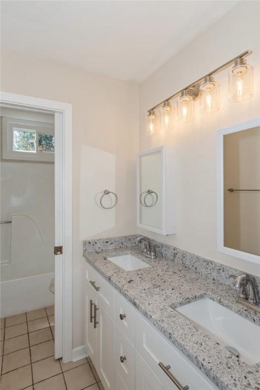 full bathroom with vanity, toilet, tile patterned floors, and tub / shower combination