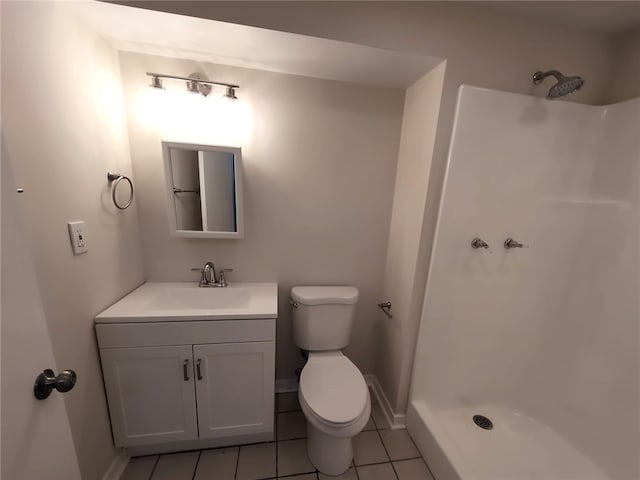 bathroom with a shower, vanity, toilet, and tile patterned floors