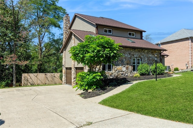 view of front of property with a front yard and a garage