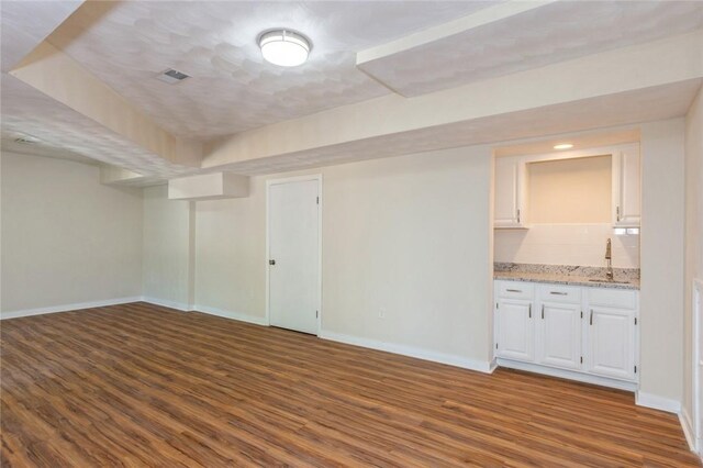 empty room with sink and hardwood / wood-style flooring